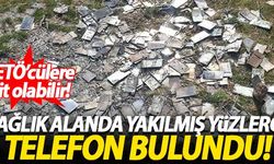 Dağlık alanda yakılmış yüzlerce telefon bulundu